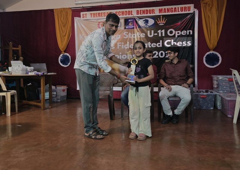 Student receiving trophy at Karnataka State U-11 FIDE Rated Chess Championship